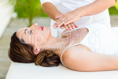 Calm woman receiving reiki treatment