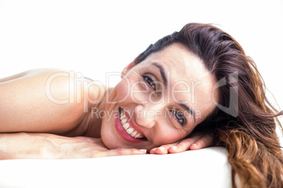 Smiling brunette getting hot stone massage