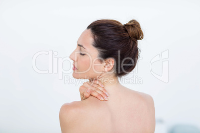 Woman touching her shoulder