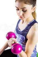 Fit woman lifting pink dumbbell