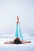 Peaceful woman lying on her bed