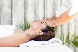 Brunette receiving forehead massage
