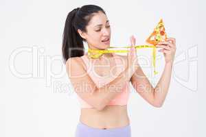 Brunette holding pizza and measuring tape