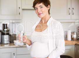 Pregnant woman having a glass of water