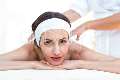 Calm woman receiving reiki treatment