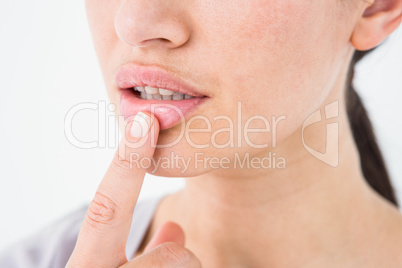 Woman pointing her lip