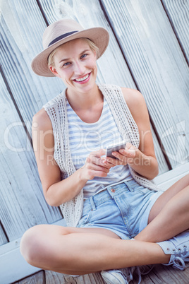 Pretty blonde woman texting with her mobile phone