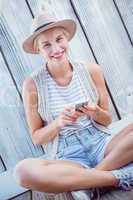 Pretty blonde woman texting with her mobile phone