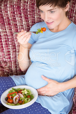 Pregnant woman eating a salad