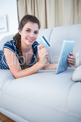 Pretty woman doing online shopping on tablet pc