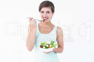 Woman eating bowl of salad