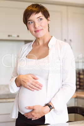 Pregnant woman holding her bump