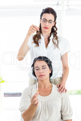 Woman being hypnotized to quit smoking