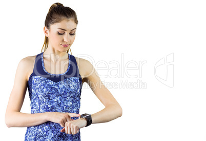 Fit brunette using her smartwatch