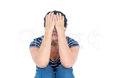 Sad woman sitting with head in hands