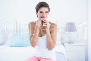 Happy woman drinking cup of tea