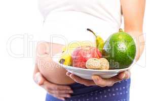 Pregnant woman showing fruit and veg
