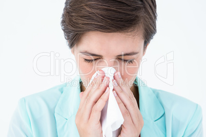 Casual brunette blowing her nose