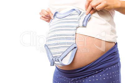 Pregnant woman holding baby clothes