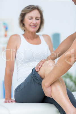 Doctor examining his patients knee