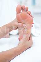 Physiotherapist doing foot massage