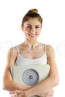 Slim woman holding weighing scales