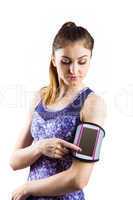 Fit woman using smartphone in armband