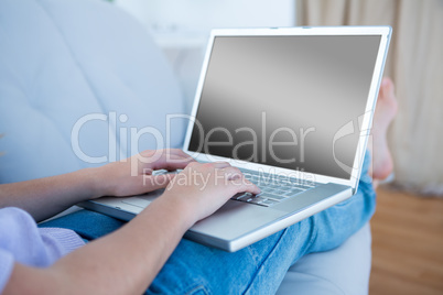 Woman using her laptop on couch