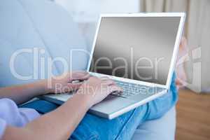 Woman using her laptop on couch