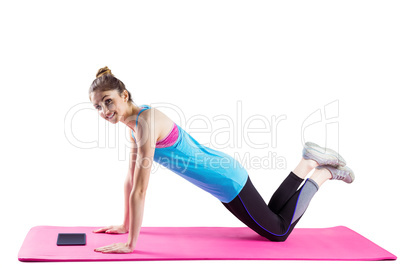 Fit woman doing press up on mat