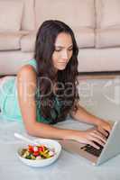 Pretty brunette using her laptop