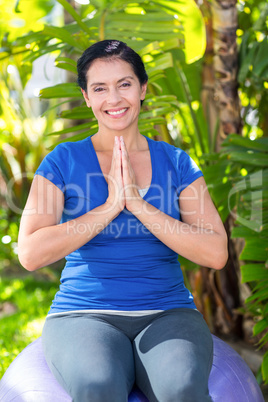 Smiling woman doing yoga