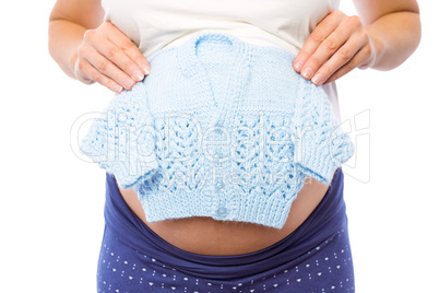 Pregnant woman holding baby clothes