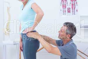 Physiotherapist examining his patient back