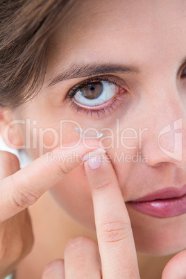 Pretty woman applying contact lens