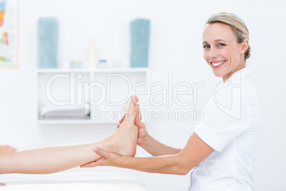 Physiotherapist doing foot massage