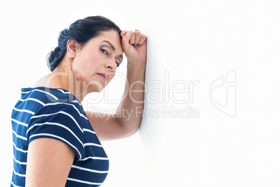 Sad woman leaning against the wall