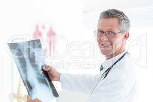 Smiling doctor holding xray