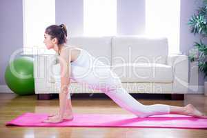 Fit woman doing yoga on mat