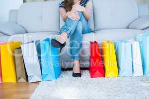 Woman with shopping bags on couch