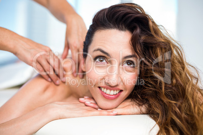 Smiling brunette getting back massage