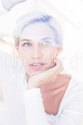 Smiling blonde woman looking through the window