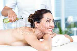 Smiling woman getting an aromatherapy treatment