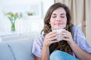 Peaceful woman holding cup of coffee