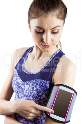 Fit woman using smartphone in armband