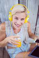 Pretty blonde woman listening music with her mobile phone and dr