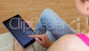 Casual woman using her tablet pc