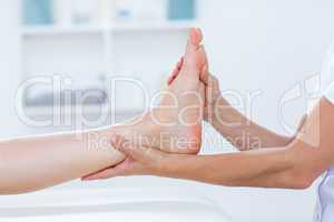 Physiotherapist doing foot massage