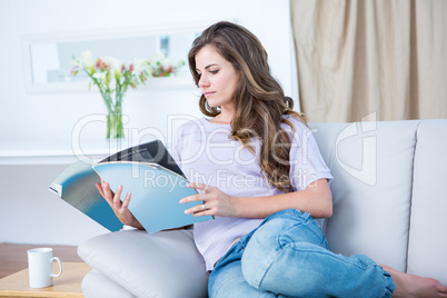 Peaceful woman reading a magazine