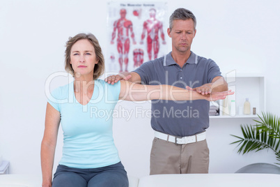 Doctor examining his patient arm